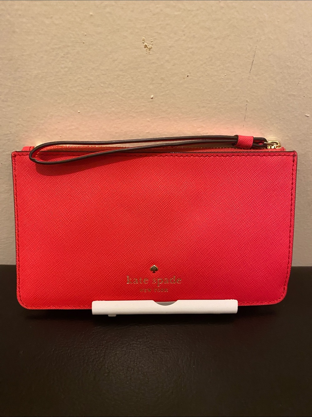 kate spade coral pink saffiano wristlet with gold logo